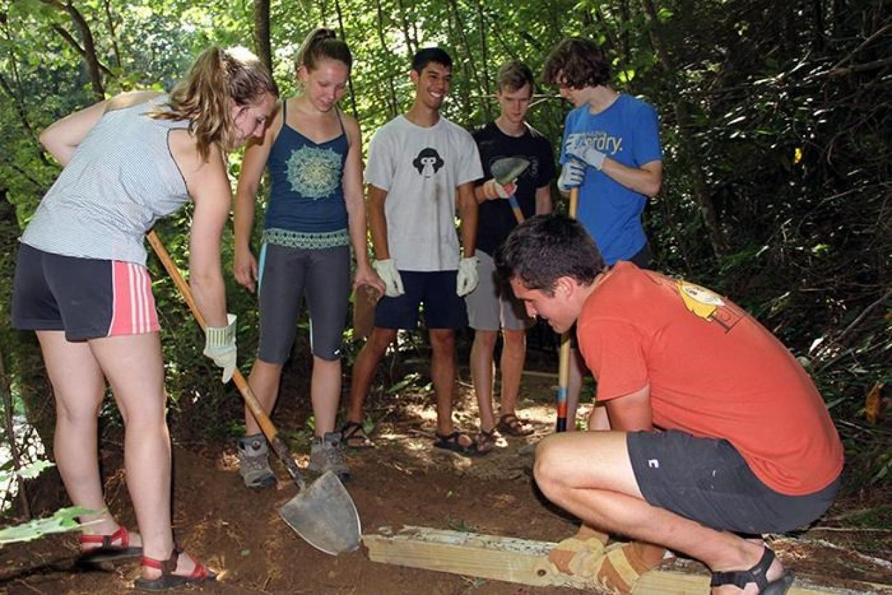 Volunteers learning trail maintenance.